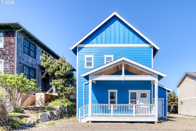 5769 NW Logan Rd, Lincoln City, OR 97367 - view of front of property with covered porch and board and batten siding