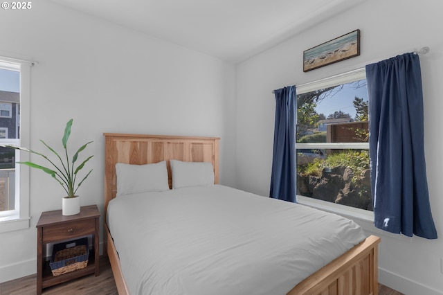 5769 NW Logan Rd, Lincoln City, OR 97367 - bedroom featuring wood finished floors, multiple windows, and baseboards