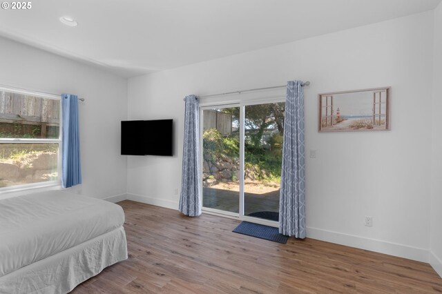 5769 NW Logan Rd, Lincoln City, OR 97367 - bedroom with access to outside, baseboards, wood finished floors, and recessed lighting