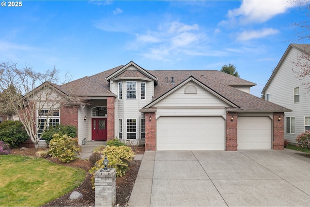 traditional home featuring a garage, driveway, brick siding, and roof with shingles