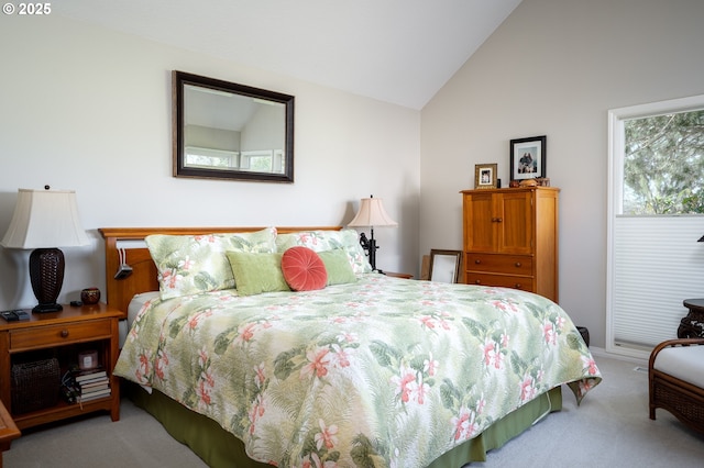 bedroom with carpet floors and vaulted ceiling