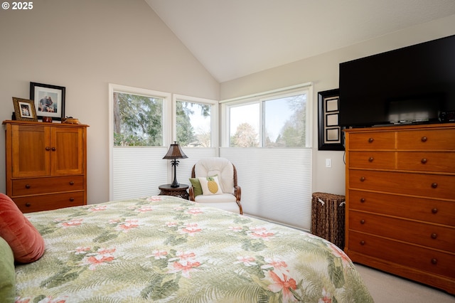 bedroom featuring high vaulted ceiling and light colored carpet