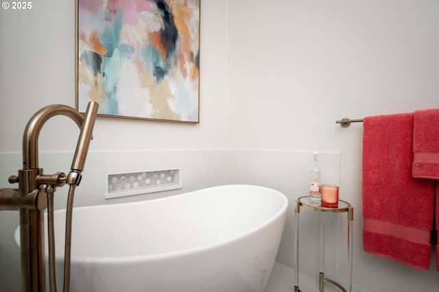 bathroom with a soaking tub and a sink