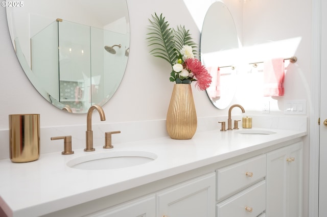 full bath featuring double vanity, walk in shower, and a sink