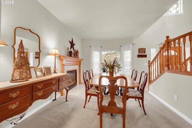 carpeted dining area featuring a tile fireplace