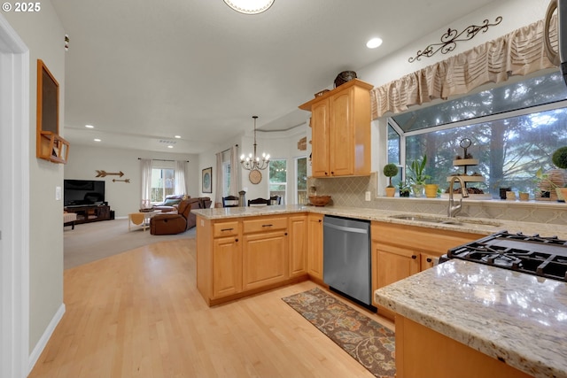 kitchen featuring hanging light fixtures, light brown cabinets, stainless steel dishwasher, a notable chandelier, and decorative backsplash