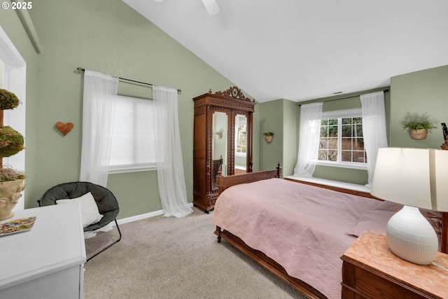 carpeted bedroom featuring lofted ceiling and ceiling fan