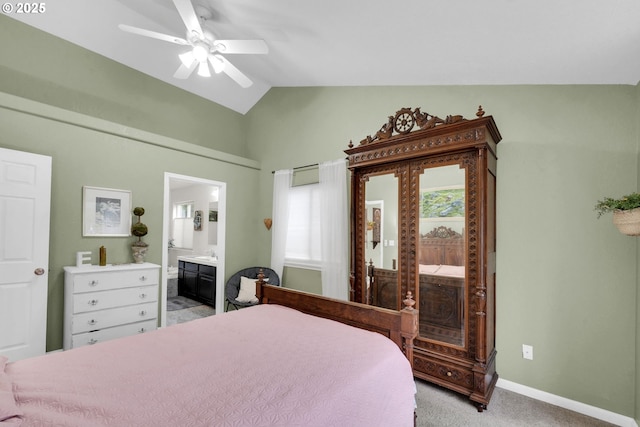 carpeted bedroom with lofted ceiling, multiple windows, ceiling fan, and ensuite bathroom