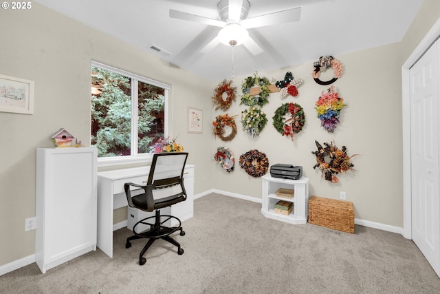 carpeted office featuring ceiling fan