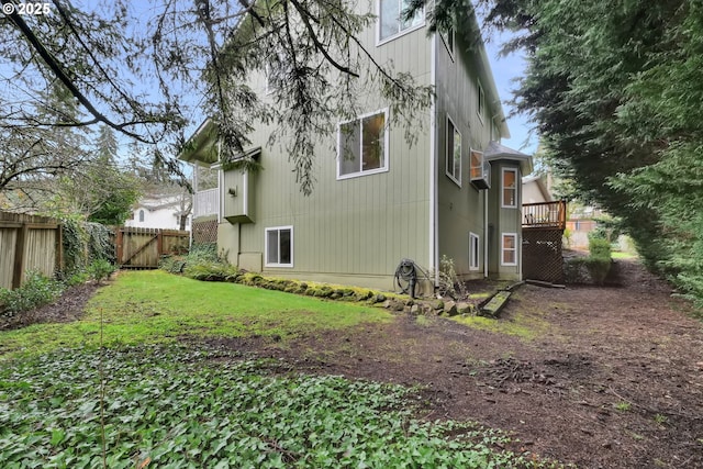 rear view of house featuring a yard