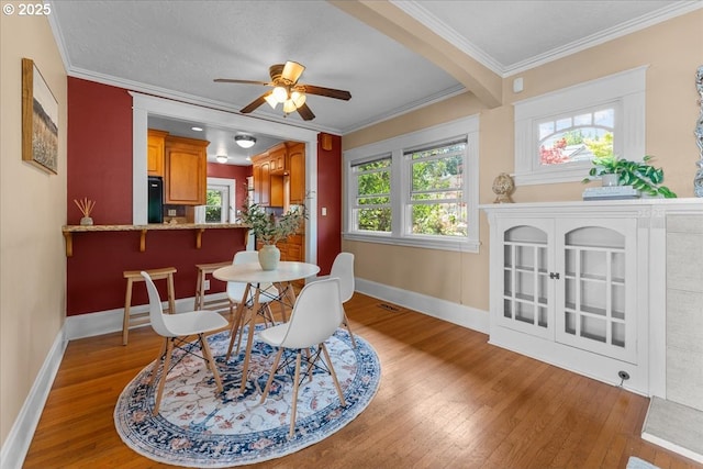 7406 N Fiske Ave, Portland, OR 97203 - dining room featuring light wood-type flooring, a ceiling fan, and ornamental molding