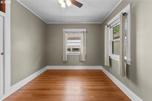 7406 N Fiske Ave, Portland, OR 97203 - spare room with wood finished floors, crown molding, a textured ceiling, and ceiling fan