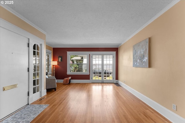 7406 N Fiske Ave, Portland, OR 97203 - foyer entrance featuring wood finished floors, a textured ceiling, crown molding, and french doors