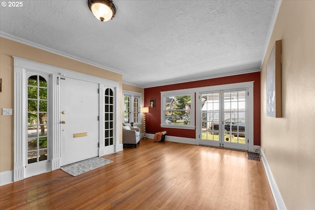 7406 N Fiske Ave, Portland, OR 97203 - foyer featuring wood finished floors, a textured ceiling, plenty of natural light, crown molding, and french doors