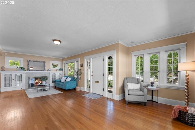 7406 N Fiske Ave, Portland, OR 97203 - foyer with a textured ceiling, wood finished floors, ornamental molding, and a fireplace