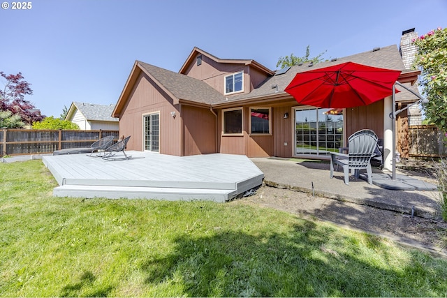 back of house featuring a deck, a patio, a fenced backyard, a shingled roof, and a yard