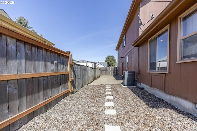 view of yard featuring a fenced backyard and central AC