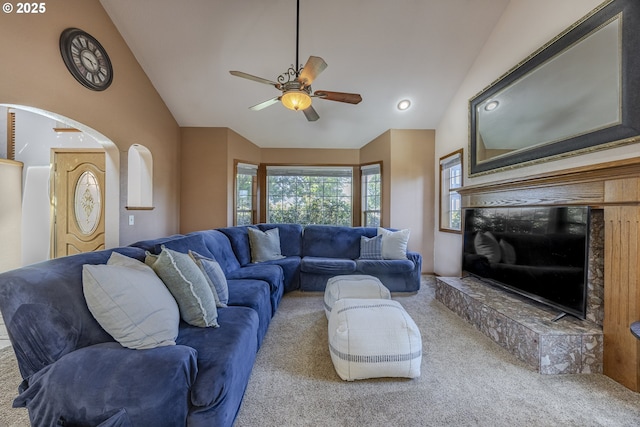 carpeted living area featuring a ceiling fan and vaulted ceiling