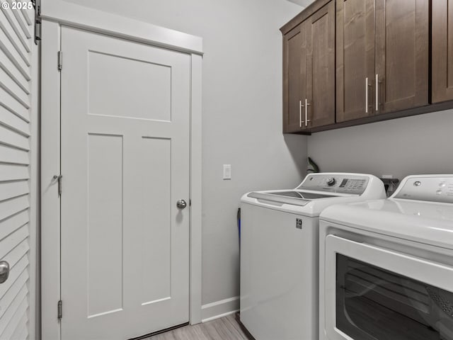 4745 S 19th St, Ridgefield, WA 98642 - laundry room featuring baseboards, cabinet space, light wood finished floors, and washer and dryer