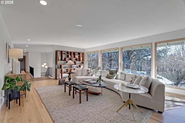 living room with plenty of natural light, light wood-style flooring, and recessed lighting