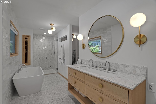 full bath featuring a freestanding tub, visible vents, vanity, tile walls, and a shower stall