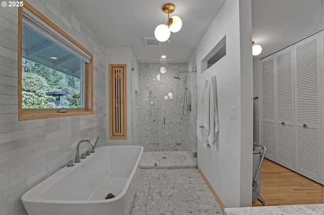 full bath featuring a shower stall, visible vents, and a closet