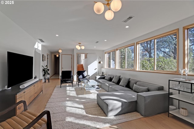 living area featuring wood finished floors, visible vents, and recessed lighting