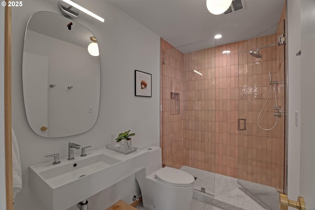 full bathroom with a stall shower, visible vents, a sink, and toilet