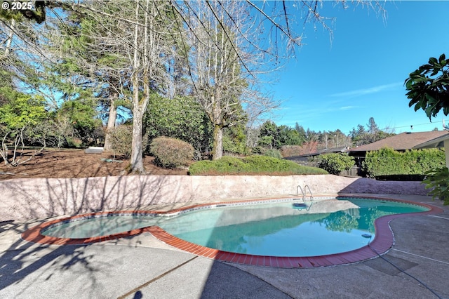 outdoor pool with a patio area