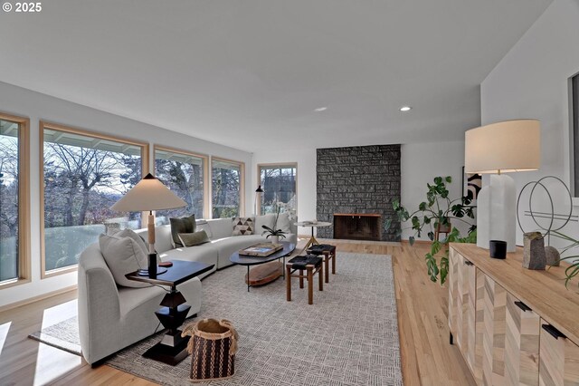 hall featuring recessed lighting, light wood-style flooring, and an upstairs landing