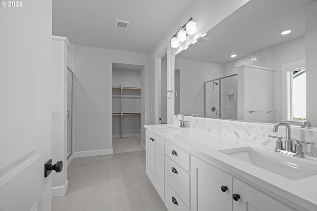 bathroom featuring vanity, an enclosed shower, and tile patterned floors