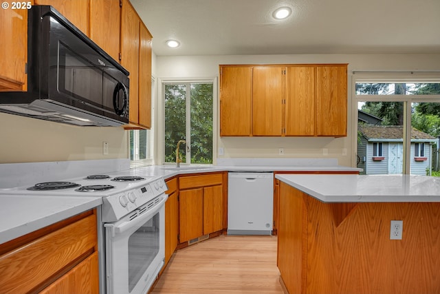 4698 Black Forest Ct, Lake Oswego, OR 97035 - kitchen featuring white appliances, a sink, light wood-style floors, healthy amount of natural light, and recessed lighting