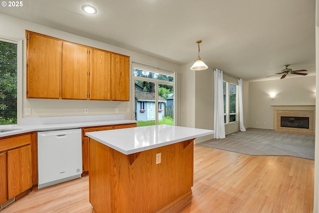 4698 Black Forest Ct, Lake Oswego, OR 97035 - kitchen featuring white dishwasher, light countertops, light wood-type flooring, a ceiling fan, and open floor plan