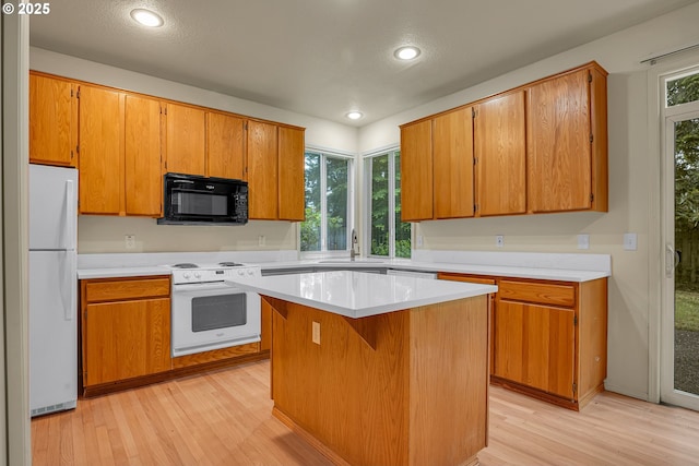 4698 Black Forest Ct, Lake Oswego, OR 97035 - kitchen with white appliances, light wood-type flooring, light countertops, and recessed lighting