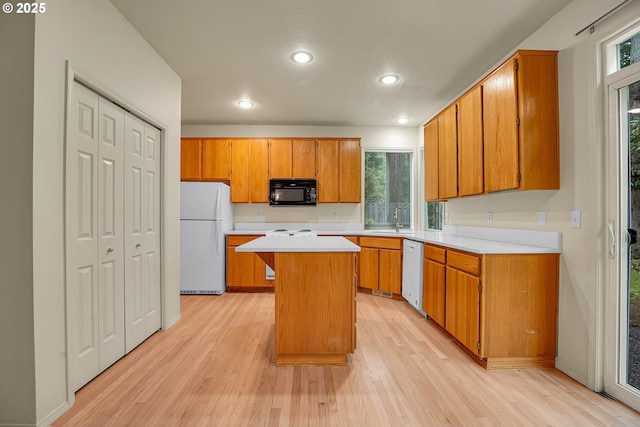 4698 Black Forest Ct, Lake Oswego, OR 97035 - kitchen with white appliances, light wood-style flooring, light countertops, a kitchen island, and recessed lighting