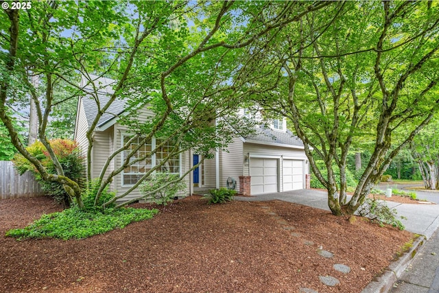 4698 Black Forest Ct, Lake Oswego, OR 97035 - view of property hidden behind natural elements featuring asphalt driveway, a shingled roof, and an attached garage