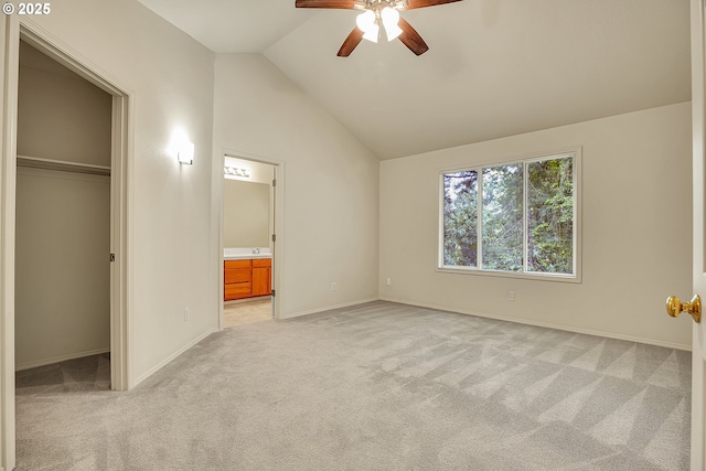4698 Black Forest Ct, Lake Oswego, OR 97035 - unfurnished bedroom with vaulted ceiling, light carpet, a closet, baseboards, and a walk in closet