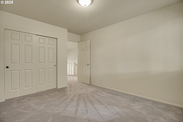 4698 Black Forest Ct, Lake Oswego, OR 97035 - unfurnished bedroom featuring carpet floors, baseboards, a textured ceiling, and a closet