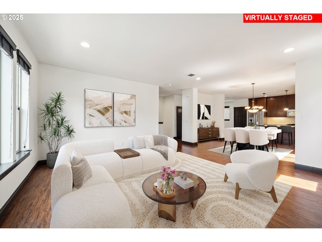 living room with visible vents, baseboards, a notable chandelier, recessed lighting, and dark wood-type flooring