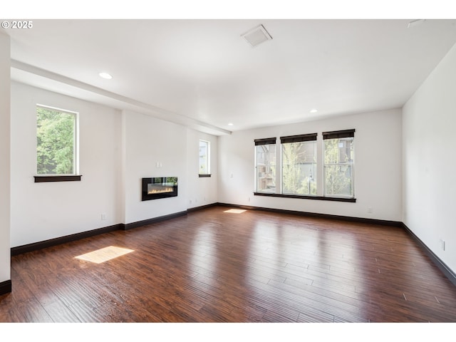 unfurnished living room with recessed lighting and a healthy amount of sunlight