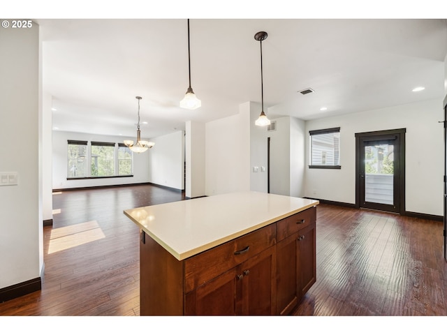 kitchen with open floor plan, dark wood finished floors, and a notable chandelier