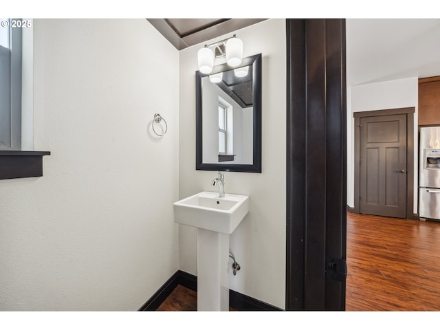bathroom featuring baseboards and wood finished floors