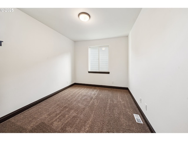 unfurnished room featuring visible vents, carpet, and baseboards