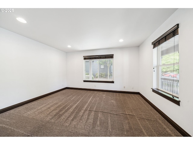 carpeted empty room with recessed lighting, baseboards, and plenty of natural light
