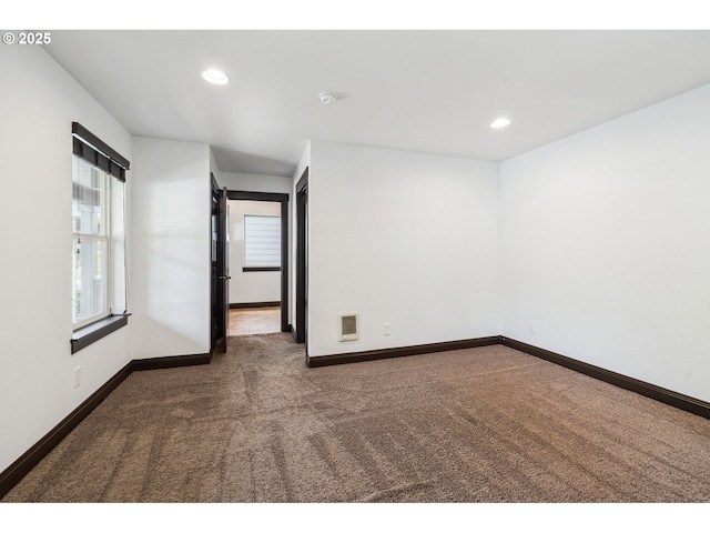 carpeted empty room featuring recessed lighting and baseboards