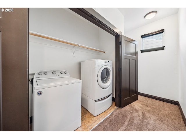 clothes washing area with light carpet, laundry area, and washing machine and clothes dryer