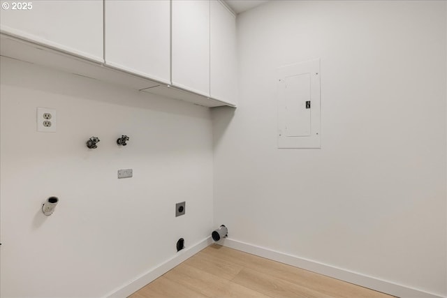 laundry area featuring cabinets, hookup for an electric dryer, electric panel, and light wood-type flooring