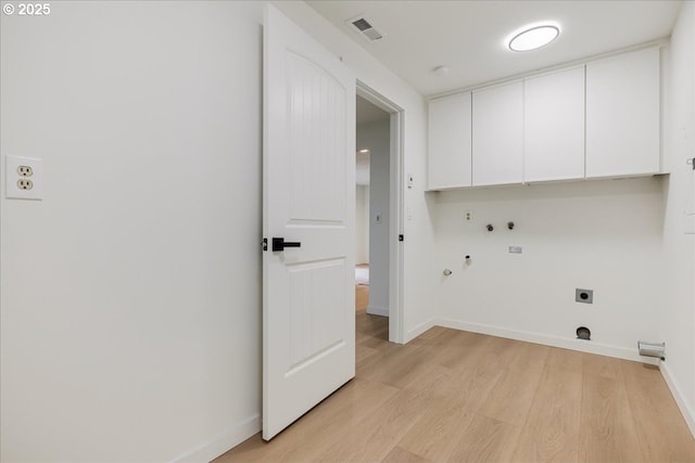 clothes washing area featuring cabinets, light wood-type flooring, hookup for a washing machine, electric dryer hookup, and hookup for a gas dryer