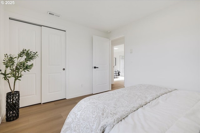 bedroom with a closet and light hardwood / wood-style flooring