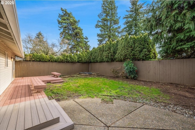 view of yard featuring a wooden deck and a patio area